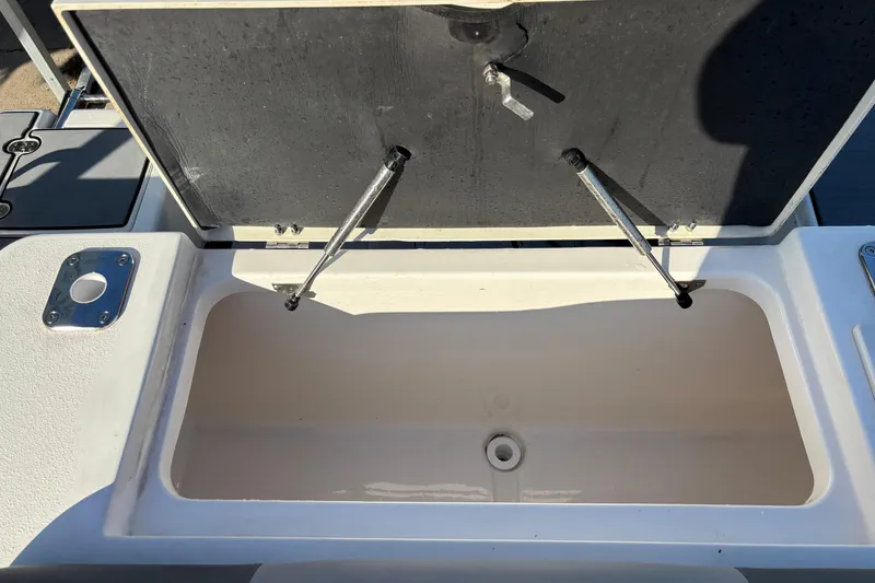 Slide: The Image of Open storage compartment on 2023 NauticStar 28 XS boat, showcasing interior space. - 17