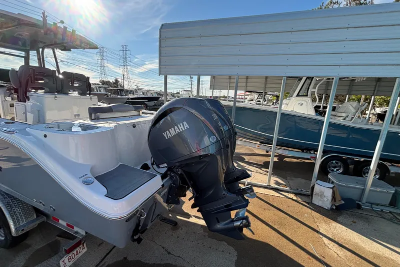 Slide: The Image of 2023 NauticStar 28 XS boat with Yamaha outboard motor in a marina setting. - 2