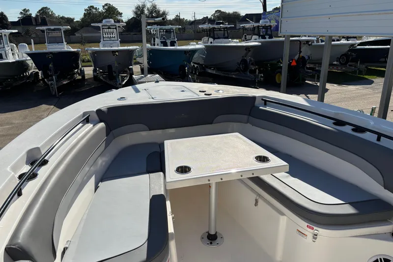 Slide: The Image of 2023 NauticStar 28 XS boat interior with seating and table, surrounded by other boats. - 3