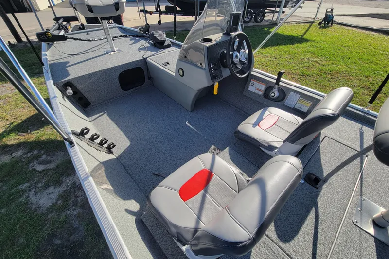 Slide: The Image of 2016 Tracker Pro 160 boat interior with steering console and seating. - 12