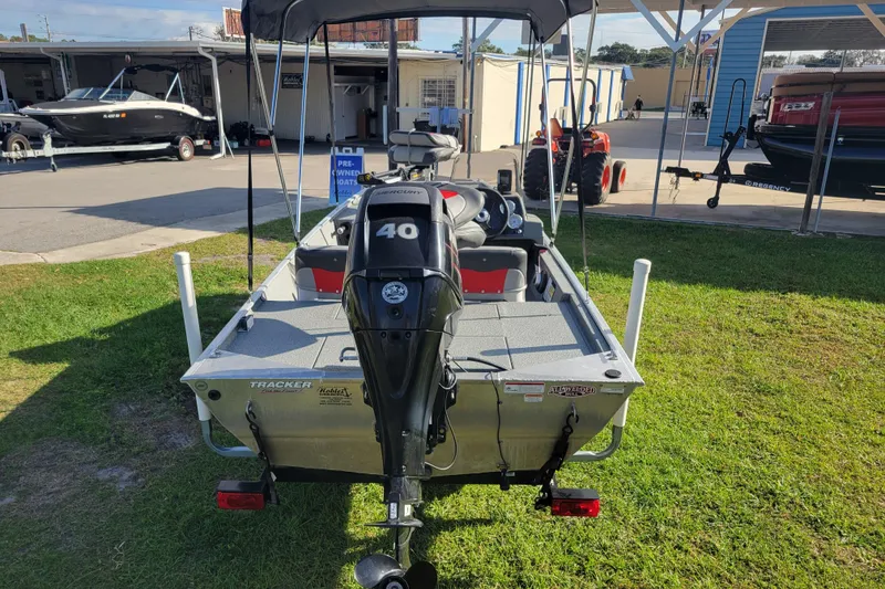 Slide: The Image of 2016 Tracker Pro 160 boat with Mercury 40 engine, parked on grass. - 3