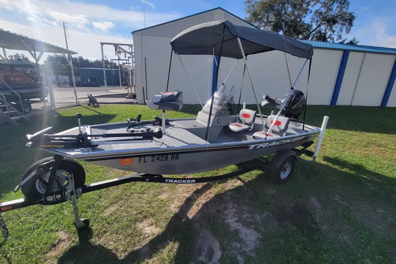Slide: The Image of 2016 Tracker Pro 160 boat with canopy on trailer, parked outdoors. - 5