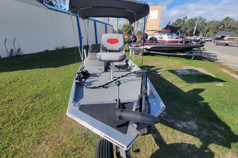 Slide: The Image of 2016 Tracker Pro 160 boat on grass, featuring a trolling motor and seating. - 6