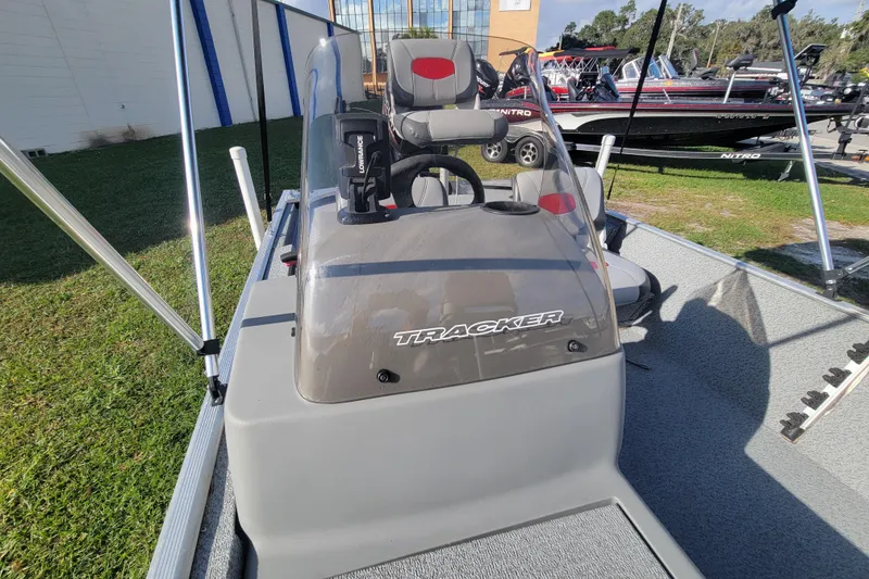 Slide: The Image of 2016 Tracker Pro 160 boat interior with steering console and seating. - 8