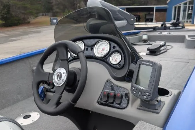 Slide: The Image of 2011 Bass Tracker PRO TEAM 175 TF boat dashboard with steering wheel and gauges. - 2
