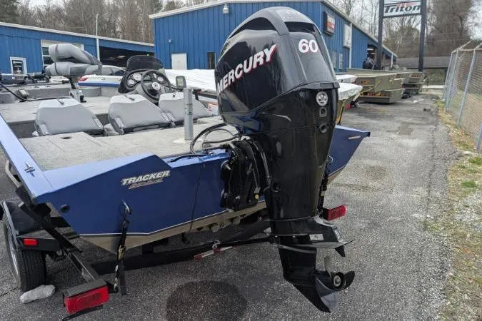 Slide: The Image of 2011 Bass Tracker PRO TEAM 175 TF boat with Mercury 60 outboard motor, parked outdoors. - 5