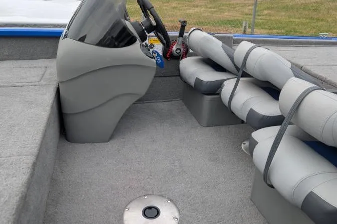 Slide: The Image of 2011 Bass Tracker PRO TEAM 175 TF boat interior with steering console and cushioned seats. - 7