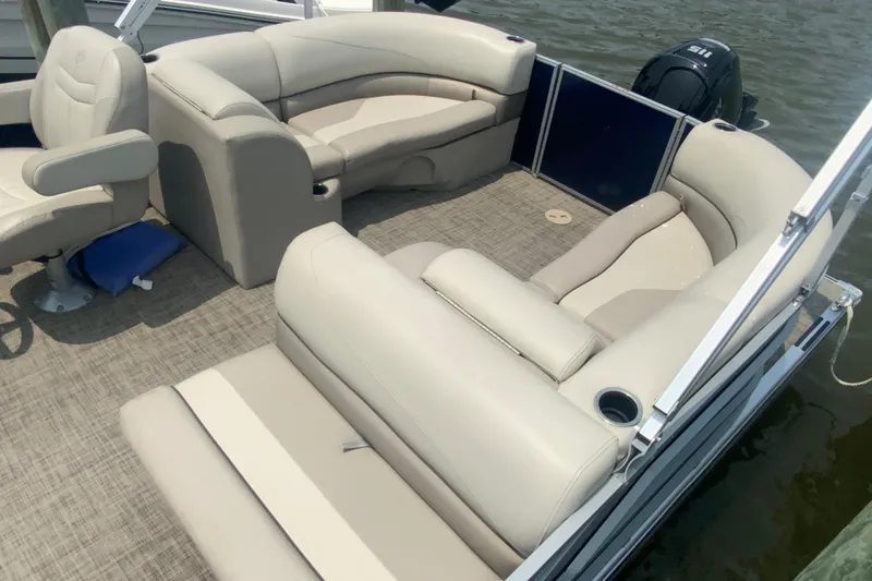 Slide: The Image of 2023 Cypress Cay Seabreeze 232 pontoon boat with beige seating and spacious deck. - 5