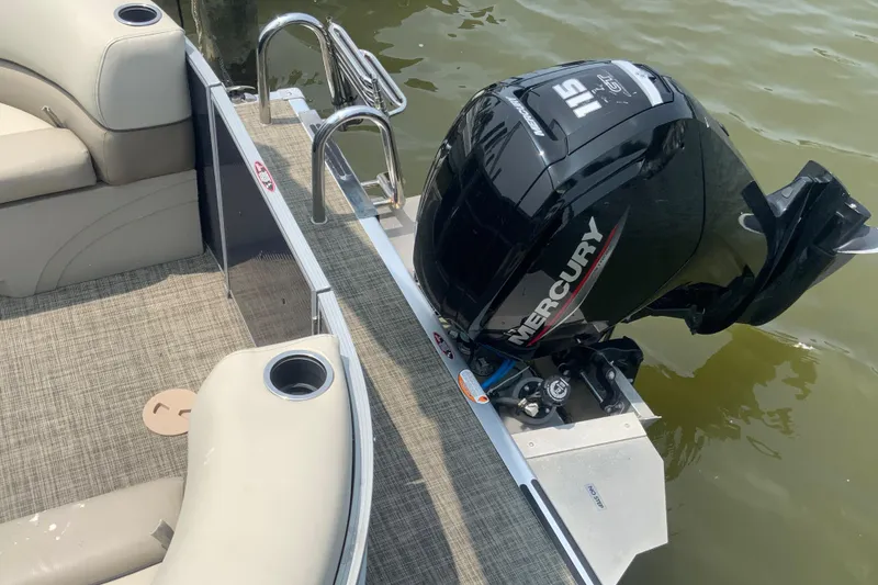 Slide: The Image of 2023 Cypress Cay Seabreeze 232 boat with Mercury 115 engine, beige seating, and cup holders. - 7