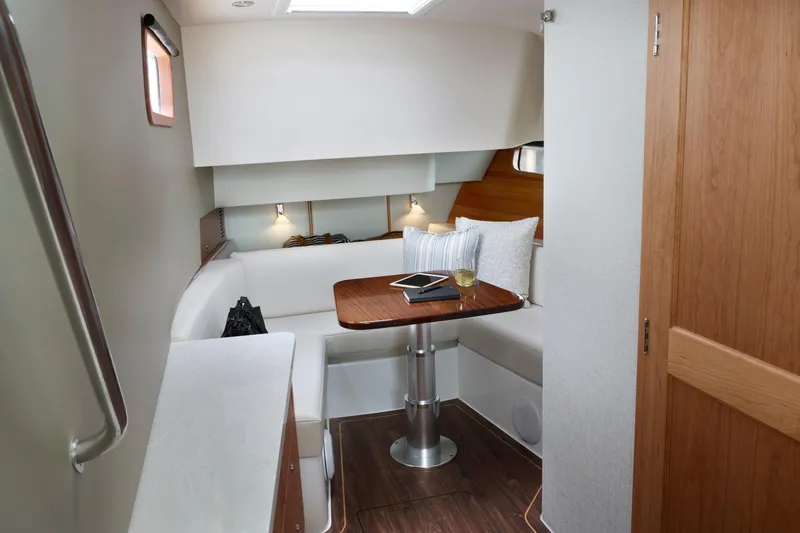 Slide: The Image of Luxurious interior of 2026 MJM 47X yacht with cozy seating and elegant table setting. - 4