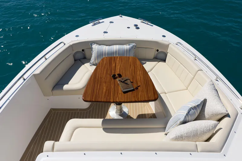 Slide: The Image of Luxurious seating area on 2026 MJM 47X yacht with elegant cushions and wooden table. - 7
