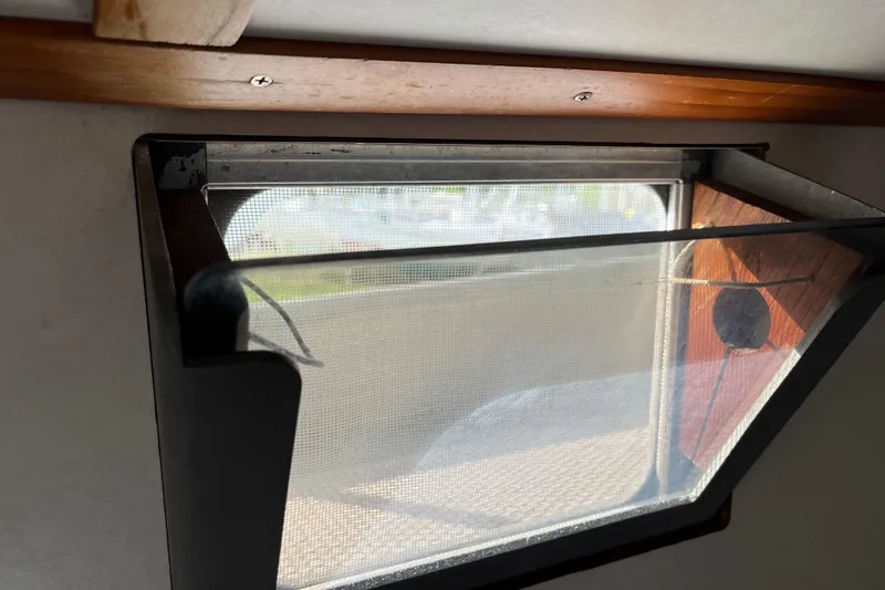 Slide: The Image of 1974 Colvin Gazelle Custom window with mesh screen, wooden trim, and open hatch. - 23