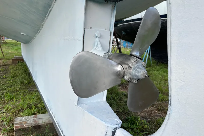 Slide: The Image of Propeller of 1974 Colvin Gazelle Custom boat on land, showcasing metal blades. - 28