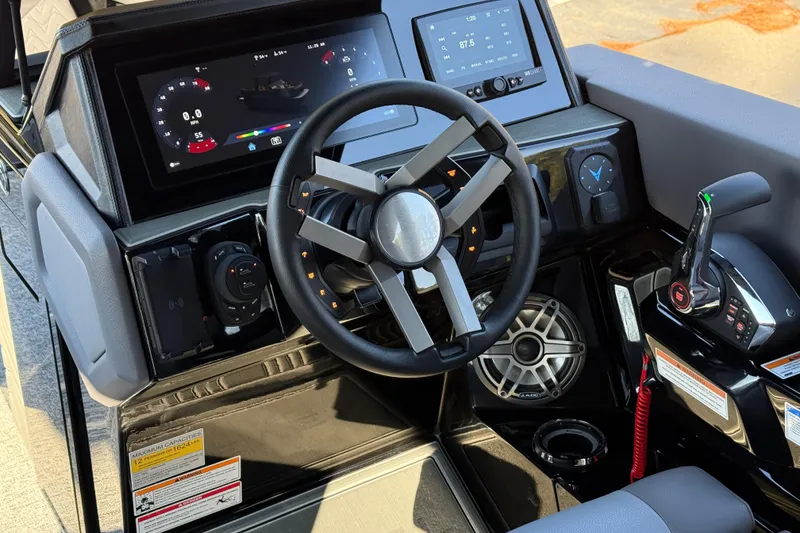 Slide: The Image of Cockpit of 2026 Revel RS25L with modern steering and digital displays. - 11
