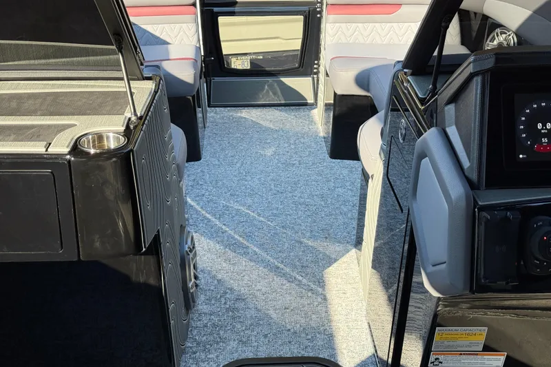 Slide: The Image of Interior of 2026 Revel RS25L boat with modern seating and dashboard. - 12
