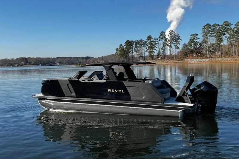 Slide: The Image of 2026 Revel RS25L boat on a serene lake with trees in the background. - 3