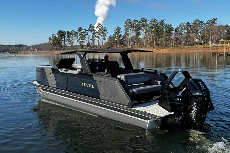 Slide: The Image of 2026 Revel RS25L boat on a serene lake with trees in the background. - 4