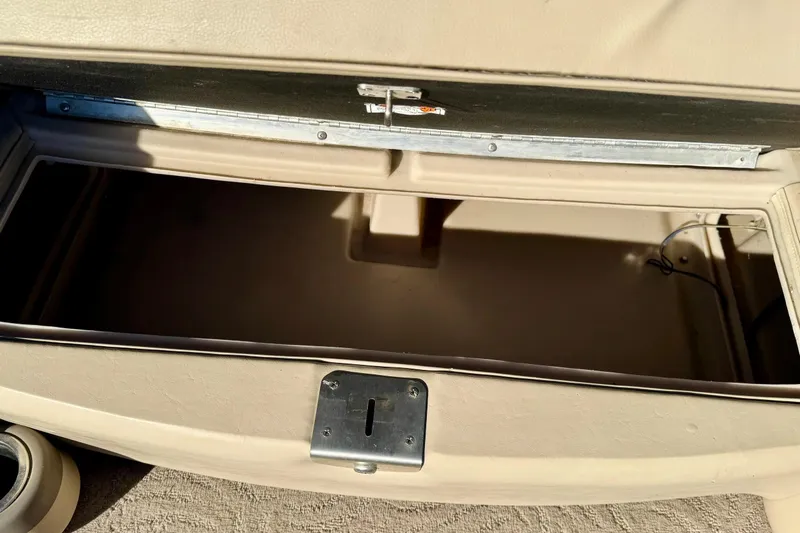 Slide: The Image of Open storage compartment on a 2012 Regency Sun Tracker Party Barge boat. - 14