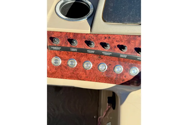 Slide: The Image of Control panel of 2012 Regency Sun Tracker Party Barge with labeled switches. - 25
