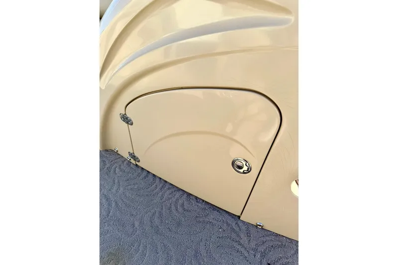 Slide: The Image of 2012 Regency Sun Tracker Party Barge storage compartment with beige finish and carpeted floor. - 39