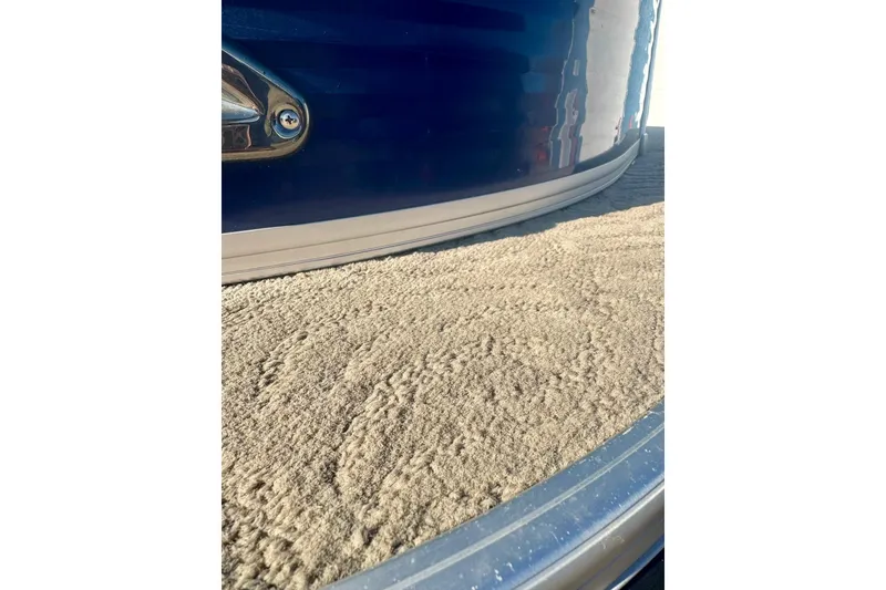 Slide: The Image of 2012 Regency Sun Tracker Party Barge with textured deck and sleek blue exterior. - 5