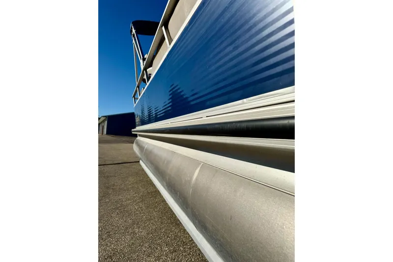 Slide: The Image of 2012 Regency Sun Tracker Party Barge pontoon boat, side view, blue and silver design. - 6