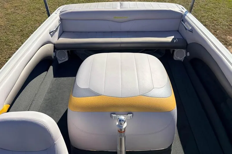 Slide: The Image of 2006 MasterCraft X-9 boat interior with white and yellow seating, showcasing spacious design. - 3