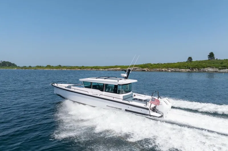 Slide: The Image of 2026 Axopar 37 XC cruising on open water, showcasing sleek design and performance. - 11