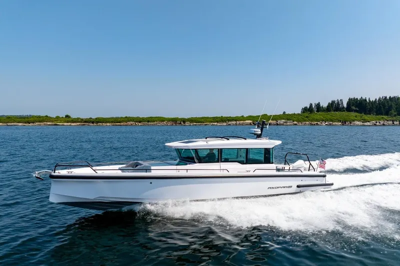 Slide: The Image of 2026 Axopar 37 XC cruising on open water, showcasing sleek design and performance. - 13