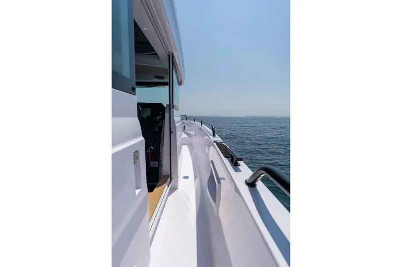 Slide: The Image of 2026 Axopar 37 XC boat side view on open water. - 24