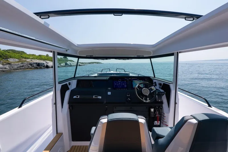 Slide: The Image of Interior view of 2026 Axopar 37 XC boat cockpit with ocean backdrop. - 48