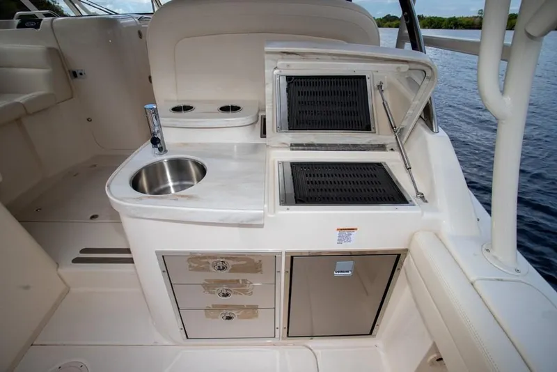 Slide: The Image of 2024 Grady-White Freedom 335 boat interior with sink, grill, and storage drawers. - 17