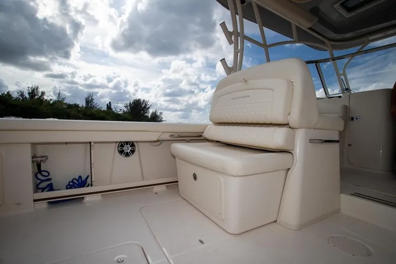 Slide: The Image of 2024 Grady-White Freedom 335 boat interior with cushioned seating and storage. - 18