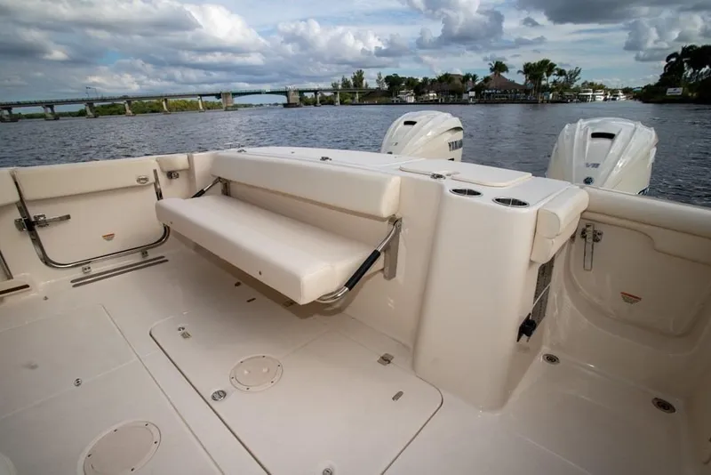 Slide: The Image of 2024 Grady-White Freedom 335 boat interior with foldable seating and dual engines. - 19
