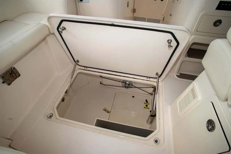 Slide: The Image of 2024 Grady-White Freedom 335 boat storage compartment with open hatch. - 22