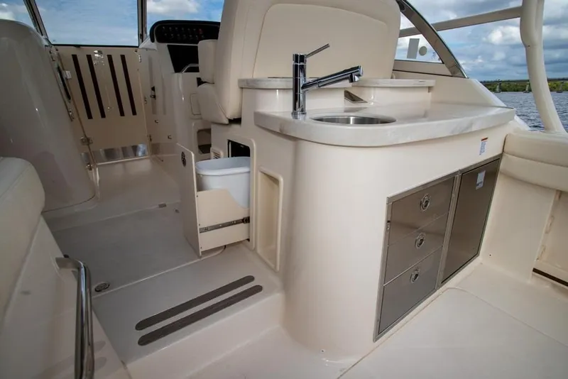 Slide: The Image of 2024 Grady-White Freedom 335 boat interior with sink and storage drawers. - 24