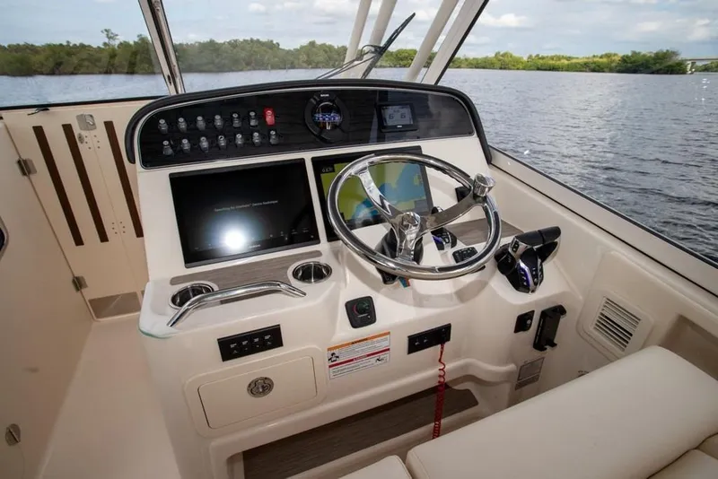 Slide: The Image of 2024 Grady-White Freedom 335 helm with modern controls and scenic water view. - 26