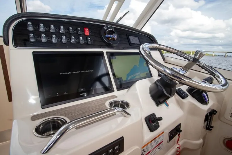 Slide: The Image of 2024 Grady-White Freedom 335 helm with advanced navigation displays and controls. - 27