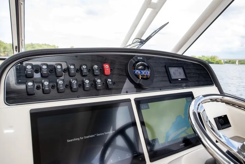 Slide: The Image of 2024 Grady-White Freedom 335 dashboard with navigation screens and controls. - 31