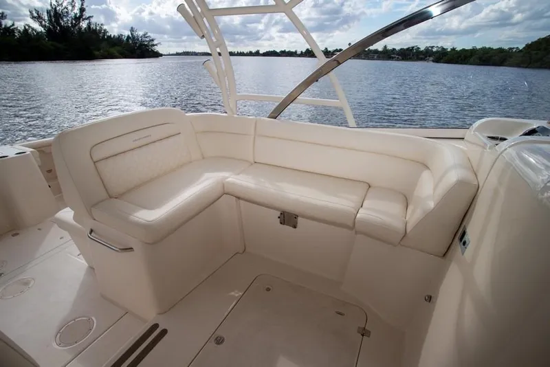 Slide: The Image of 2024 Grady-White Freedom 335 boat interior with luxurious seating by the water. - 33