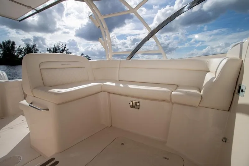 Slide: The Image of 2024 Grady-White Freedom 335 boat interior with luxurious seating under a blue sky. - 34