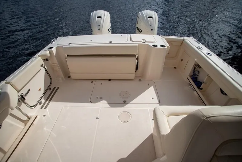 Slide: The Image of 2024 Grady-White Freedom 335 boat deck with twin engines on water. - 35
