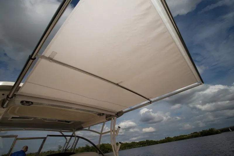 Slide: The Image of 2024 Grady-White Freedom 335 boat with extended canopy under a partly cloudy sky. - 38