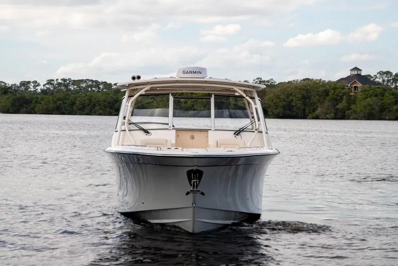 Slide: The Image of 2024 Grady-White Freedom 335 boat on calm water, front view. - 4