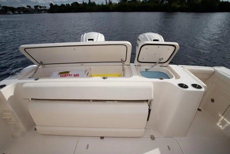 Slide: The Image of 2024 Grady-White Freedom 335 boat with open storage compartments and life jackets. - 43