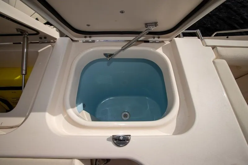 Slide: The Image of Livewell compartment on 2024 Grady-White Freedom 335 boat, open lid view. - 44