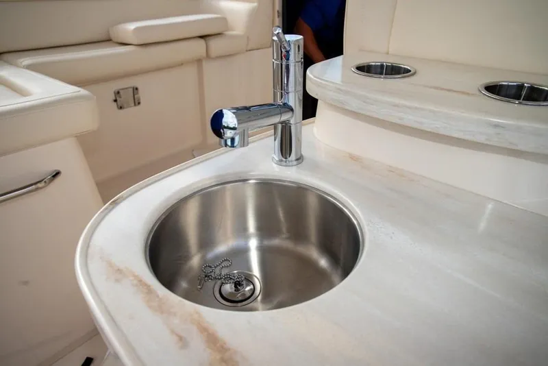 Slide: The Image of Luxury sink area on 2024 Grady-White Freedom 335 boat, featuring stainless steel fixtures. - 47