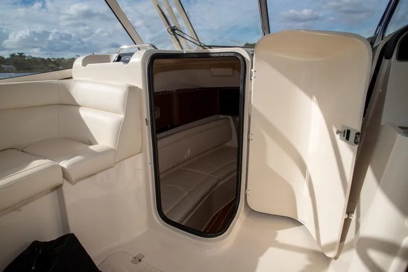 Slide: The Image of 2024 Grady-White Freedom 335 boat interior with open cabin door and seating. - 48