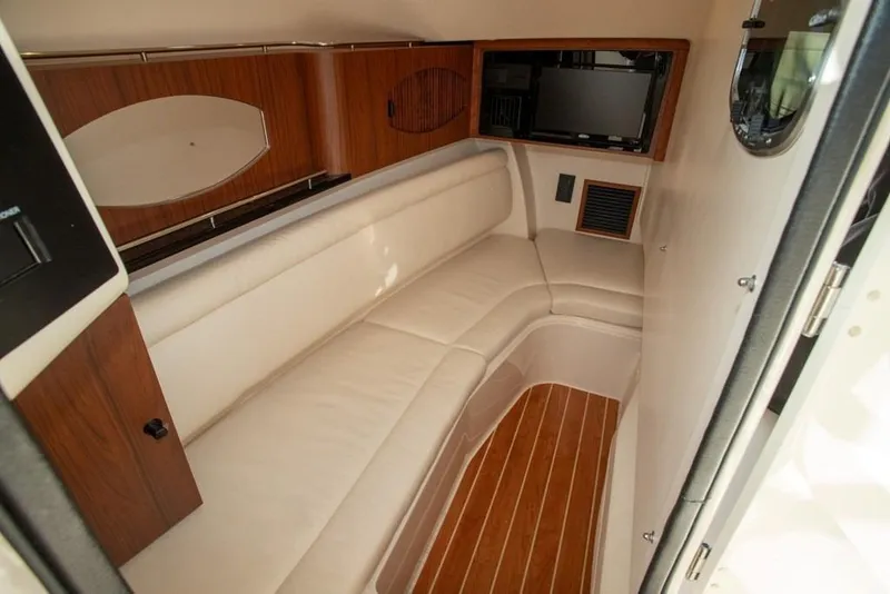 Slide: The Image of 2024 Grady-White Freedom 335 cabin interior with wood accents and comfortable seating. - 49