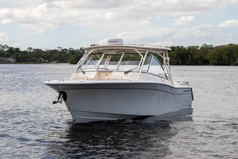 Slide: The Image of 2024 Grady-White Freedom 335 boat on calm water, showcasing sleek design and modern features. - 5